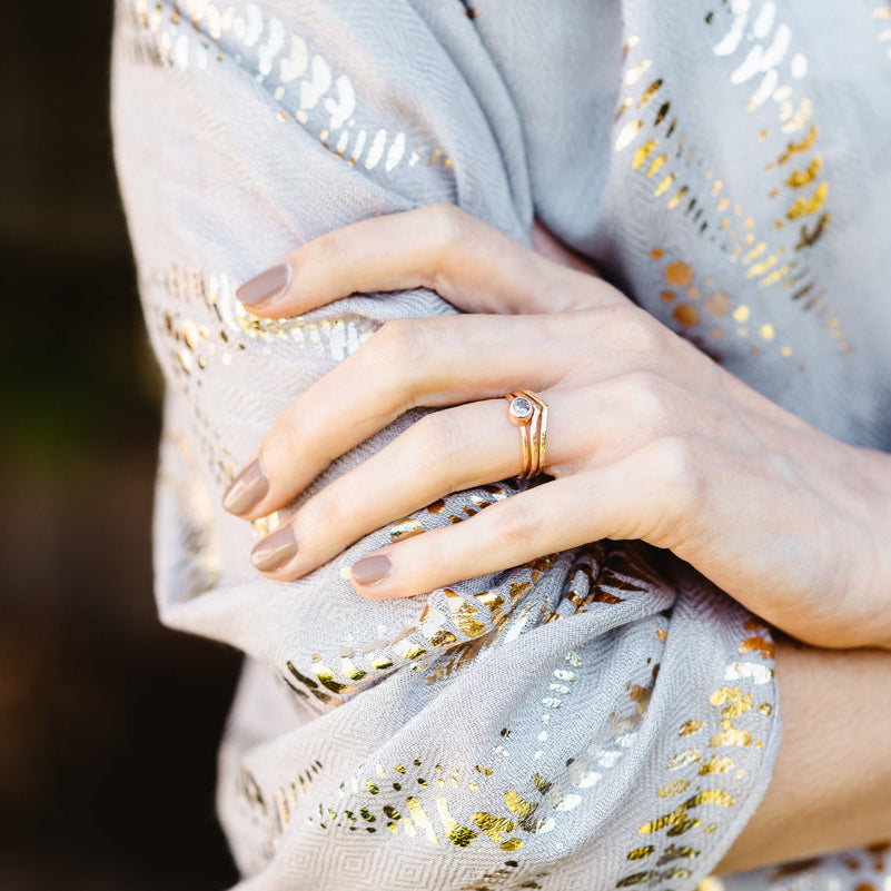 A pair of stacking wishbone ring with a spinel ring