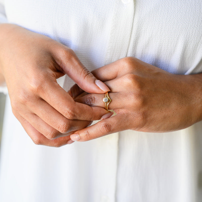 A pair of 18ct yellow gold rings, one diamond solitaire and one wishbone
