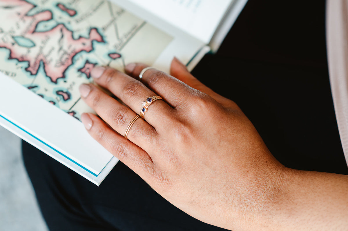 A stack of slim stone set rings, a pair of skinny bands and a mid ring, in 9ct recyled gold. 