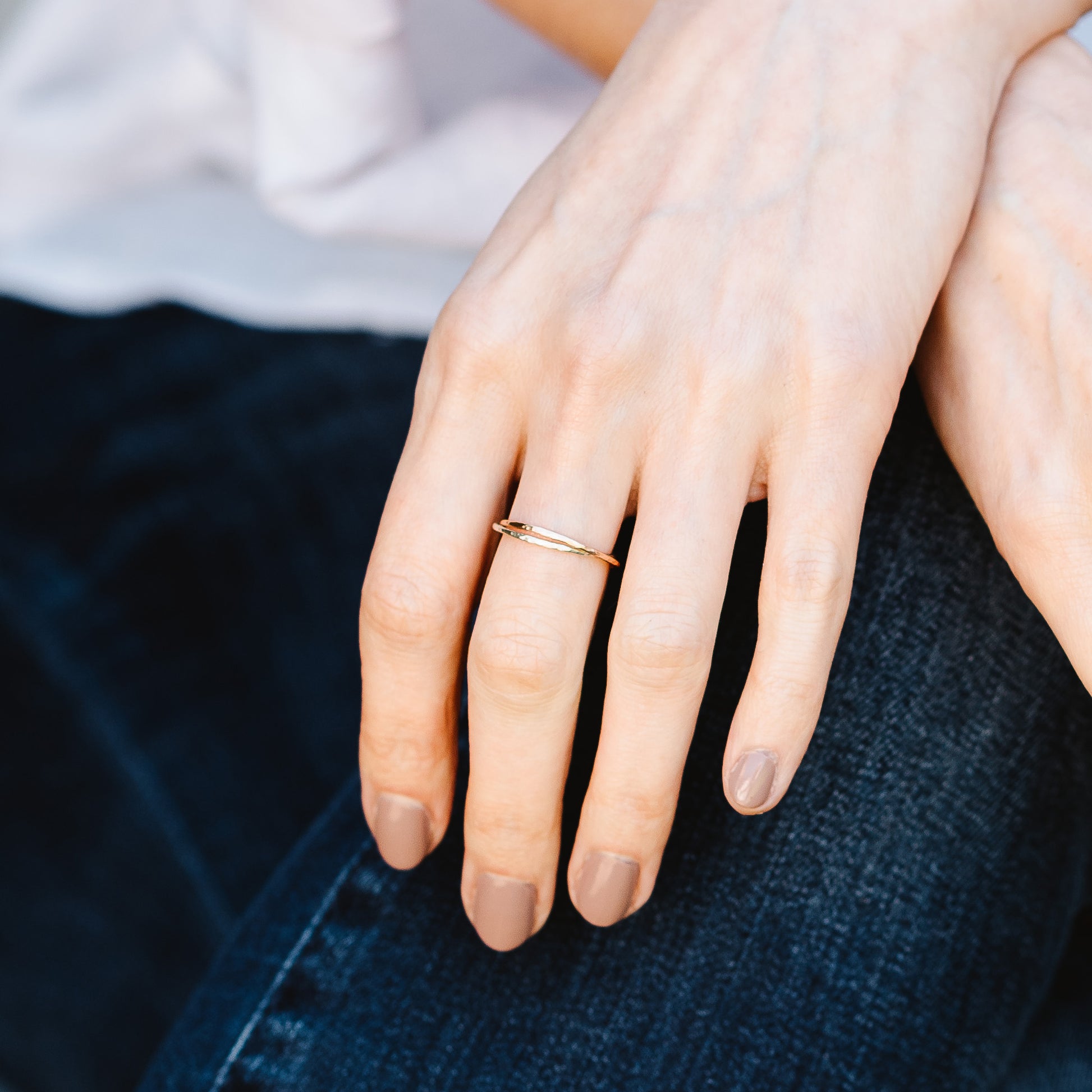 A pair of joined or russian wedding ring style bands in 9ct white and rose gold, with a hammered finish