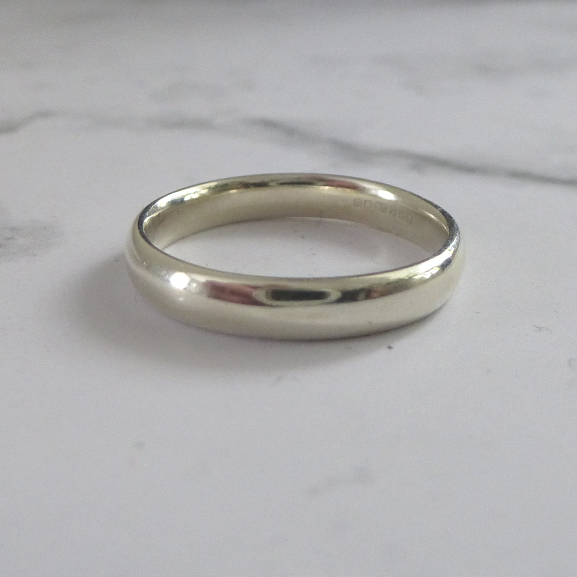 handmade wedding band in 9ct white gold, smooth finish, soft modern court shape, 100% recycled gold