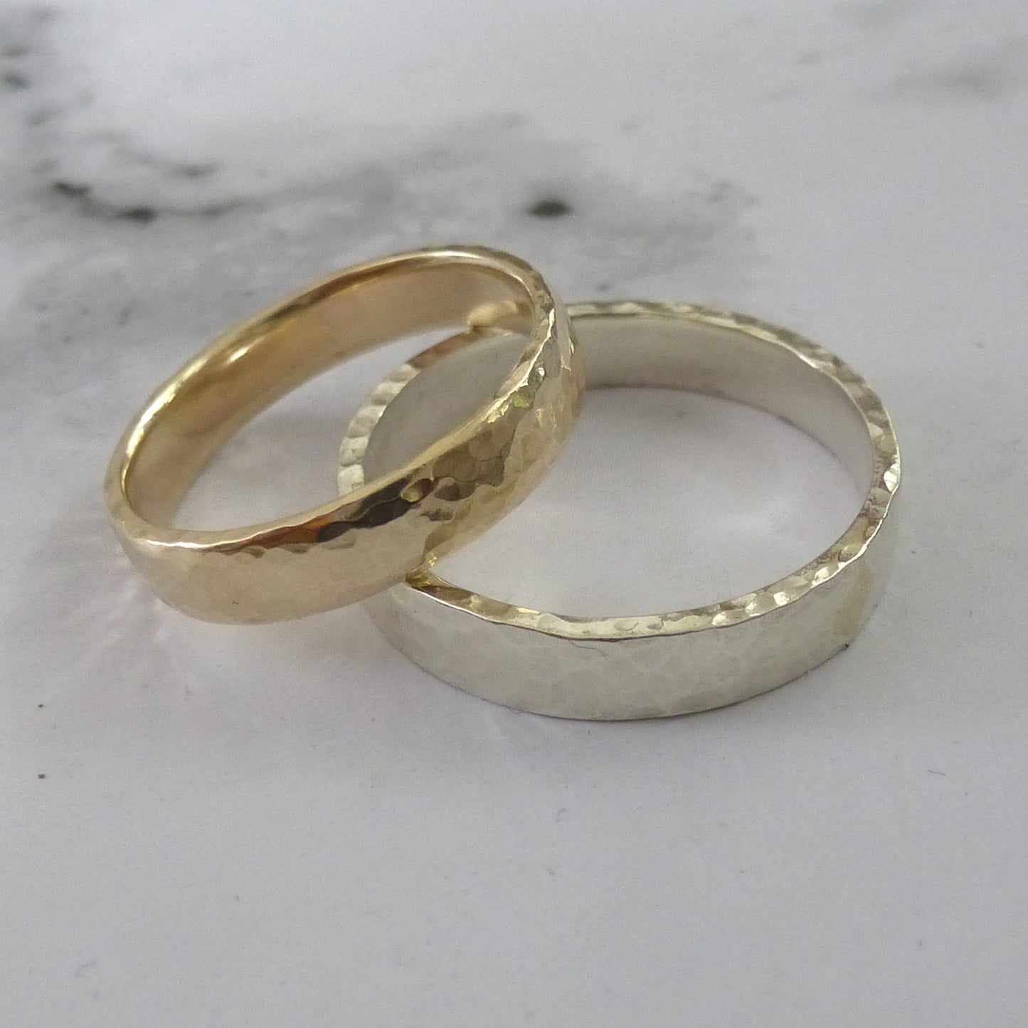 A pair of hammered wedding rings, 4mm, recycled gold. Top band in yellow with soft edges, lower band 9ct white gold, square edges