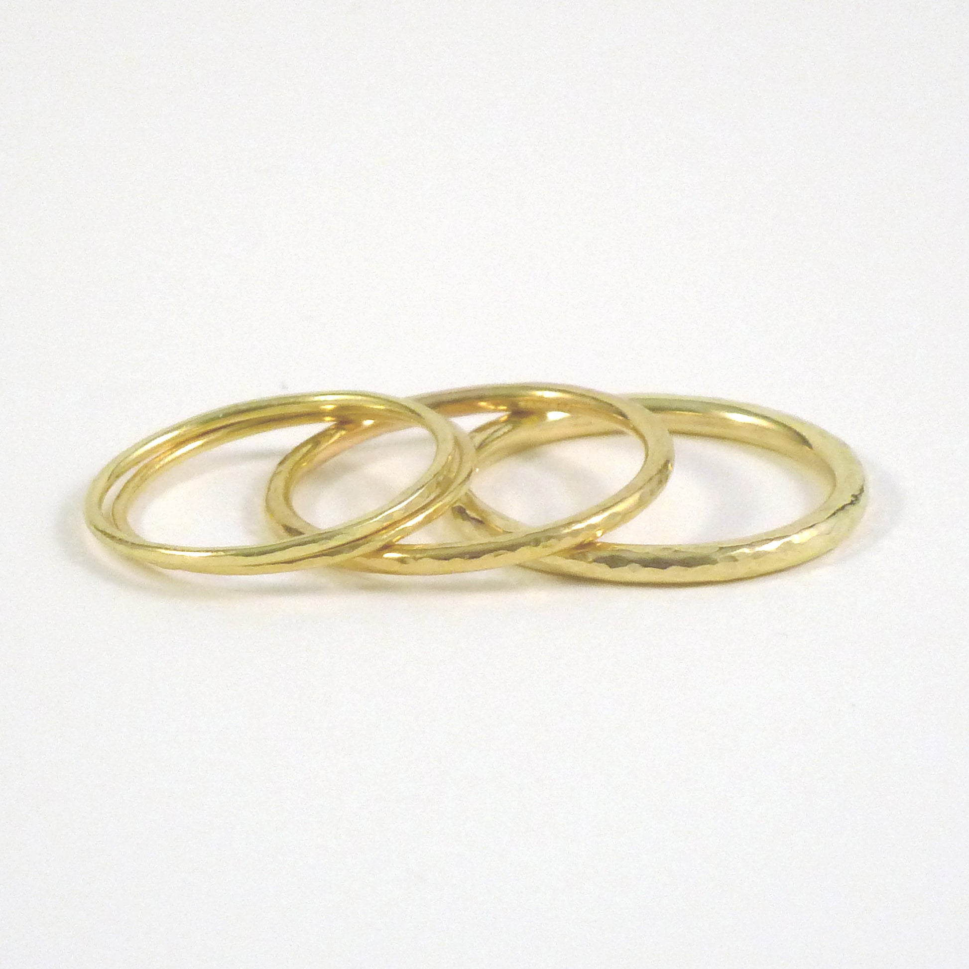 3 stacked bands, from the left 1mm, 1.5mm and 2mm, 18ct yellow gold, hammered finish