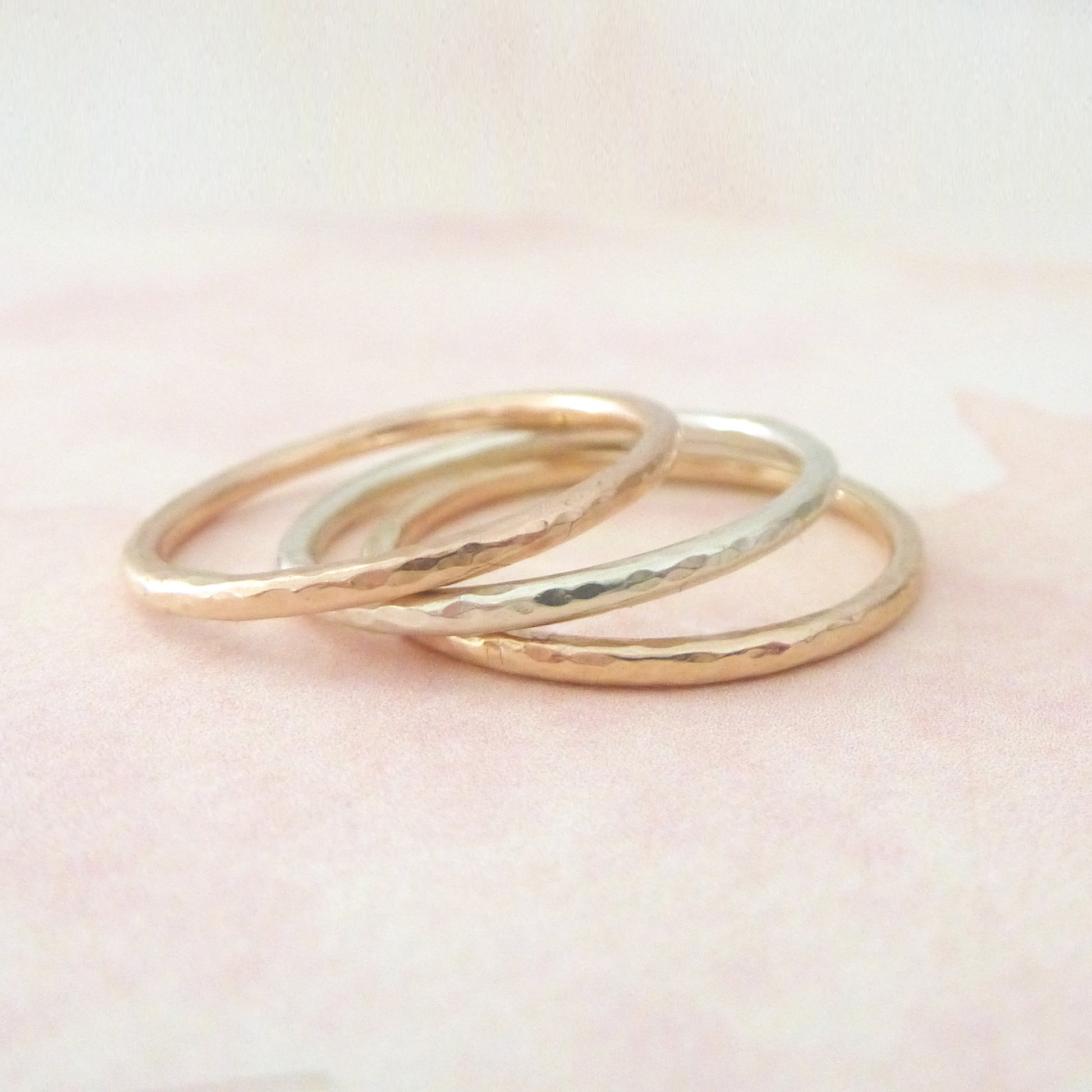 A stack of 3 hammered bands, 1.2mm in diameter in 9ct gold