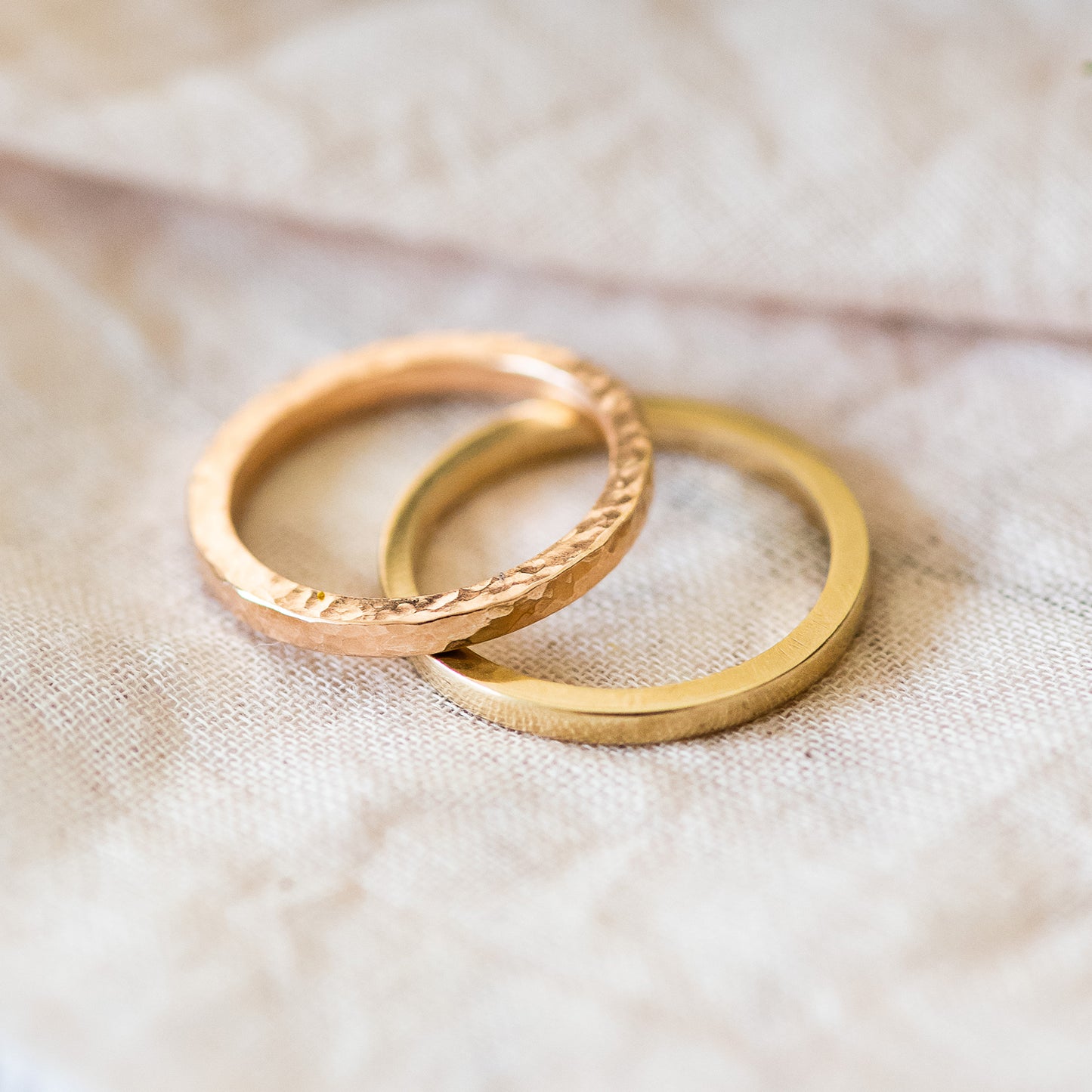 two square profile bands, both 9ct gold, one hammered one smooth