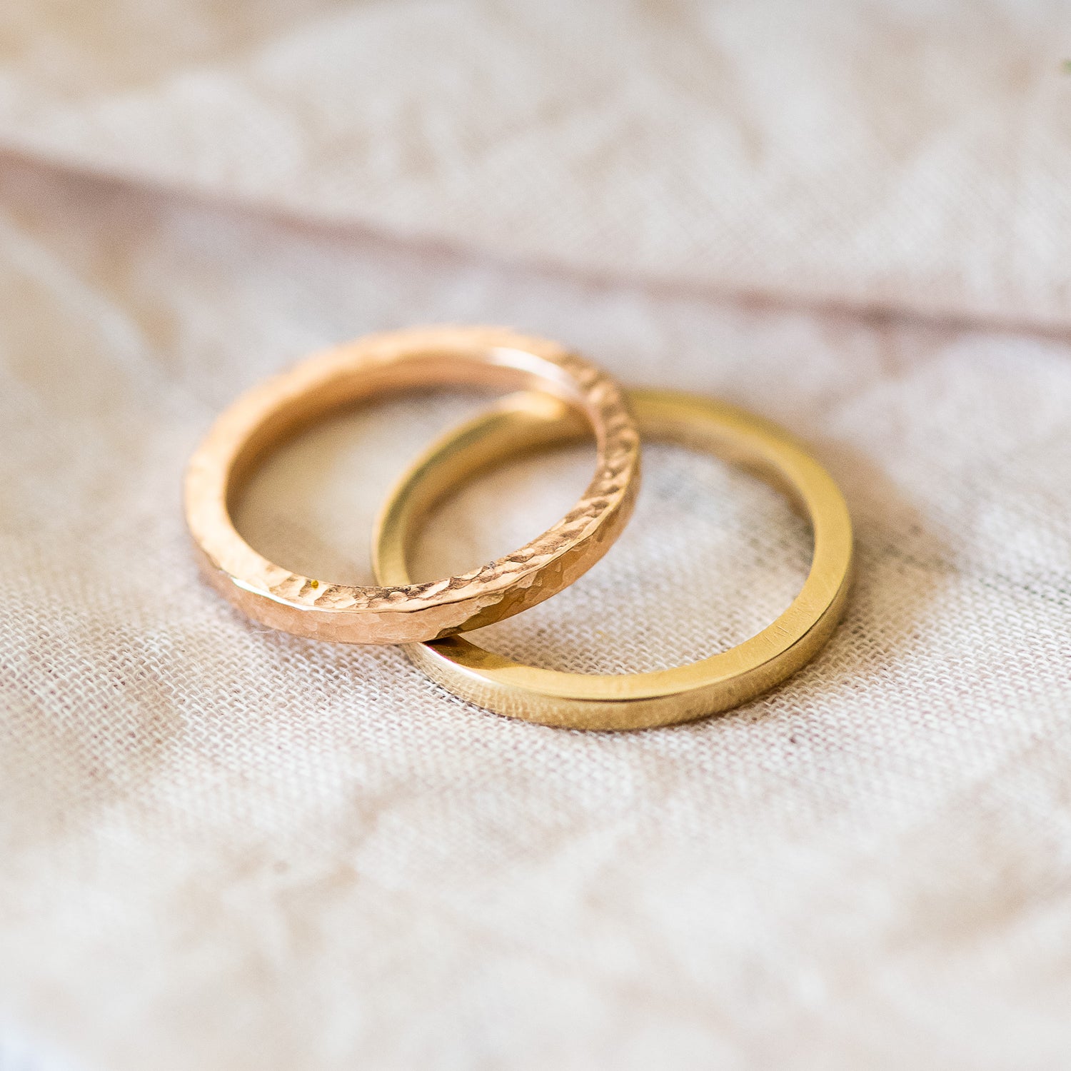 two square profile bands, both 9ct gold, one hammered one smooth