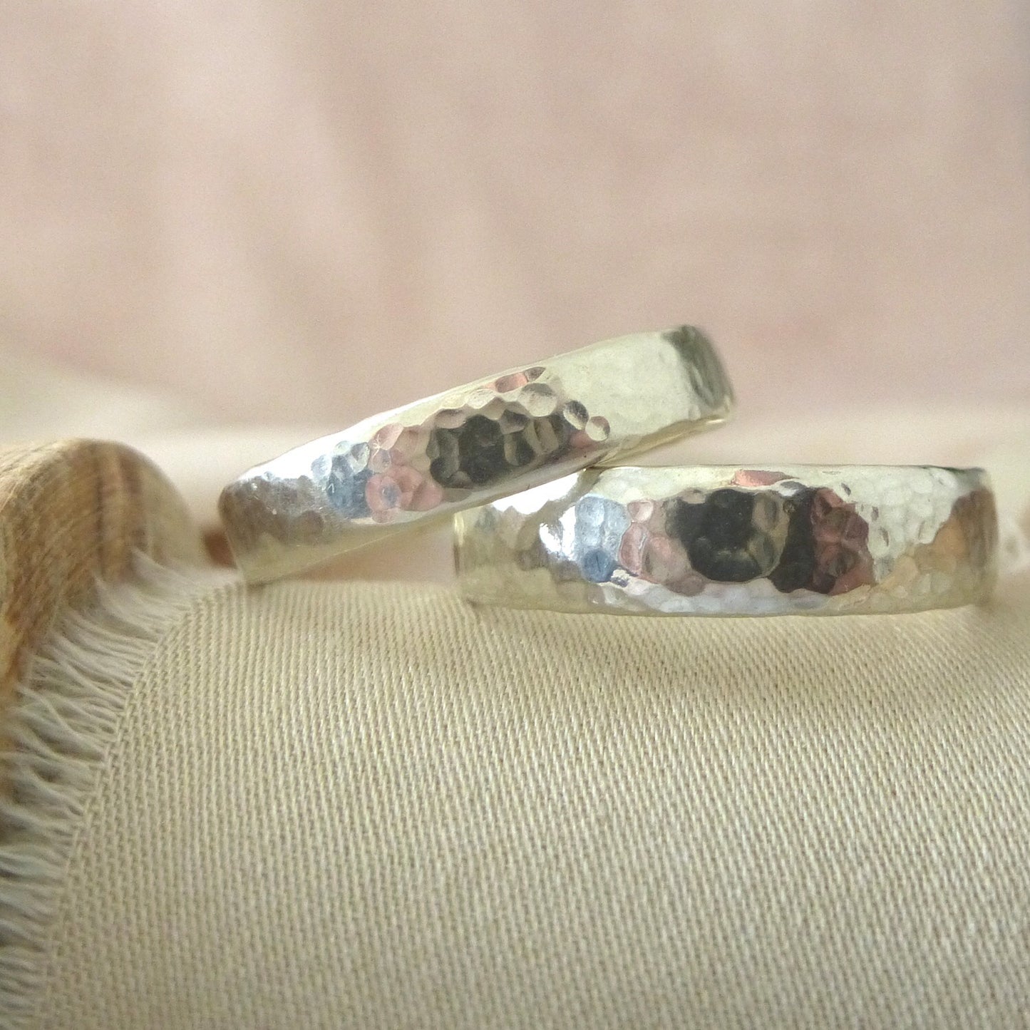A pair of recycled 9ct white gold wedding band, hammered finishes, soft modern court shape