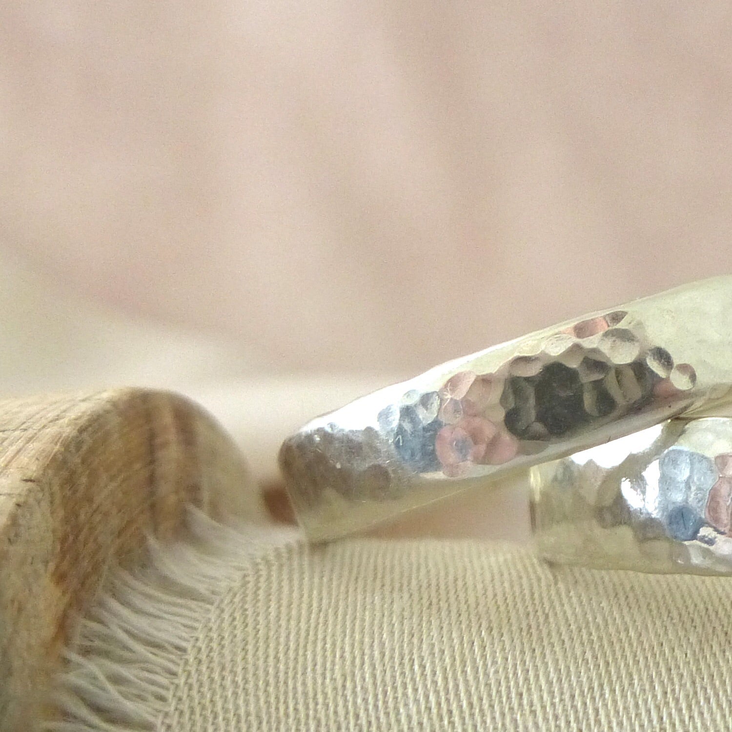 Close up of hammered finish, 9ct white gold handmade wedding ring.