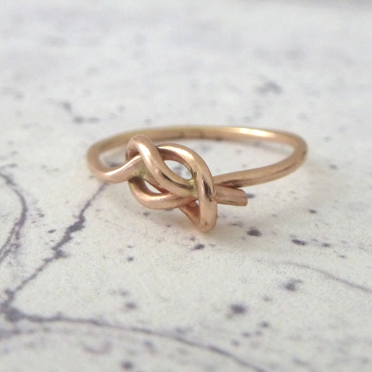 slim rose gold knot ring, close up 