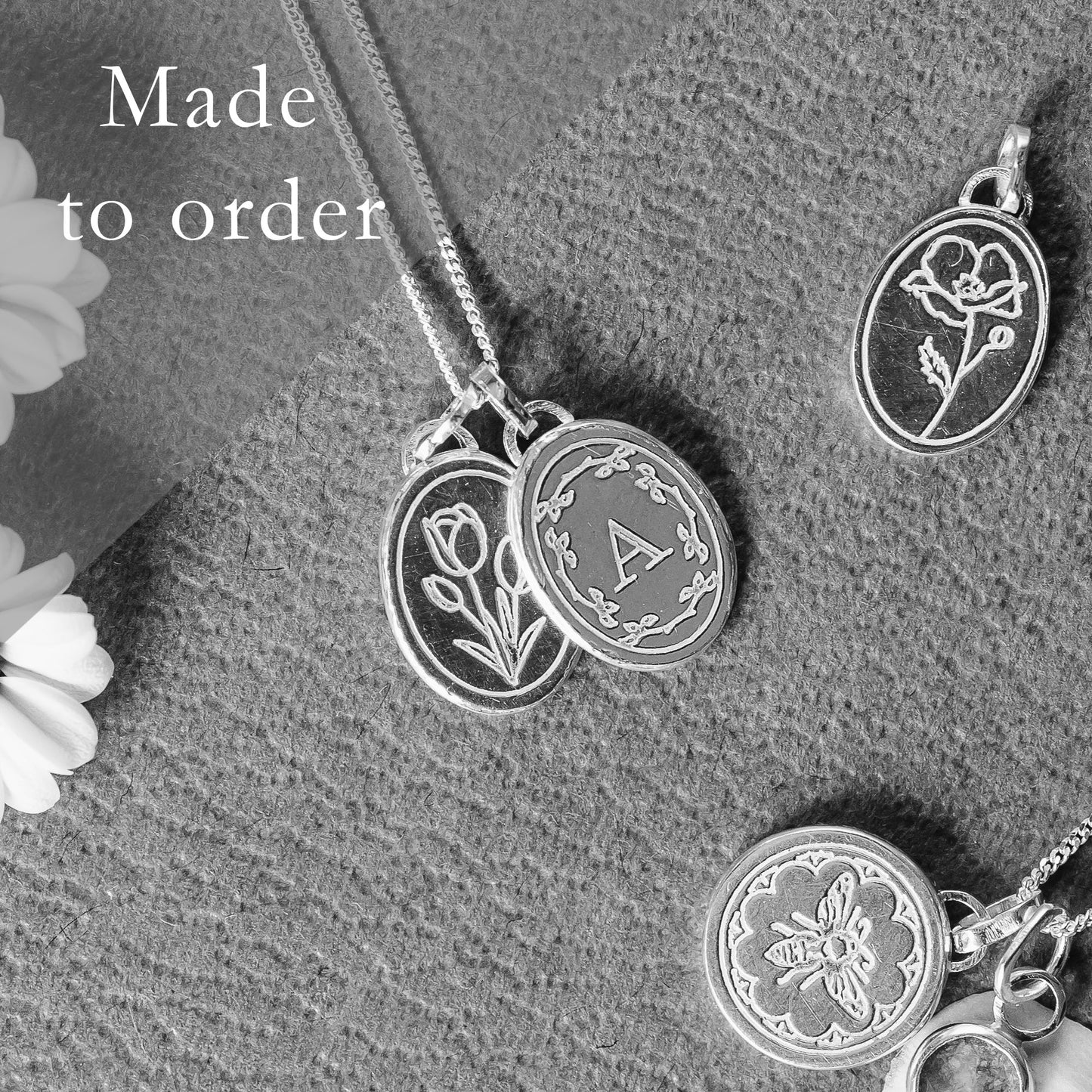 Gold initial necklace made to order pictured with some other engraved necklaces