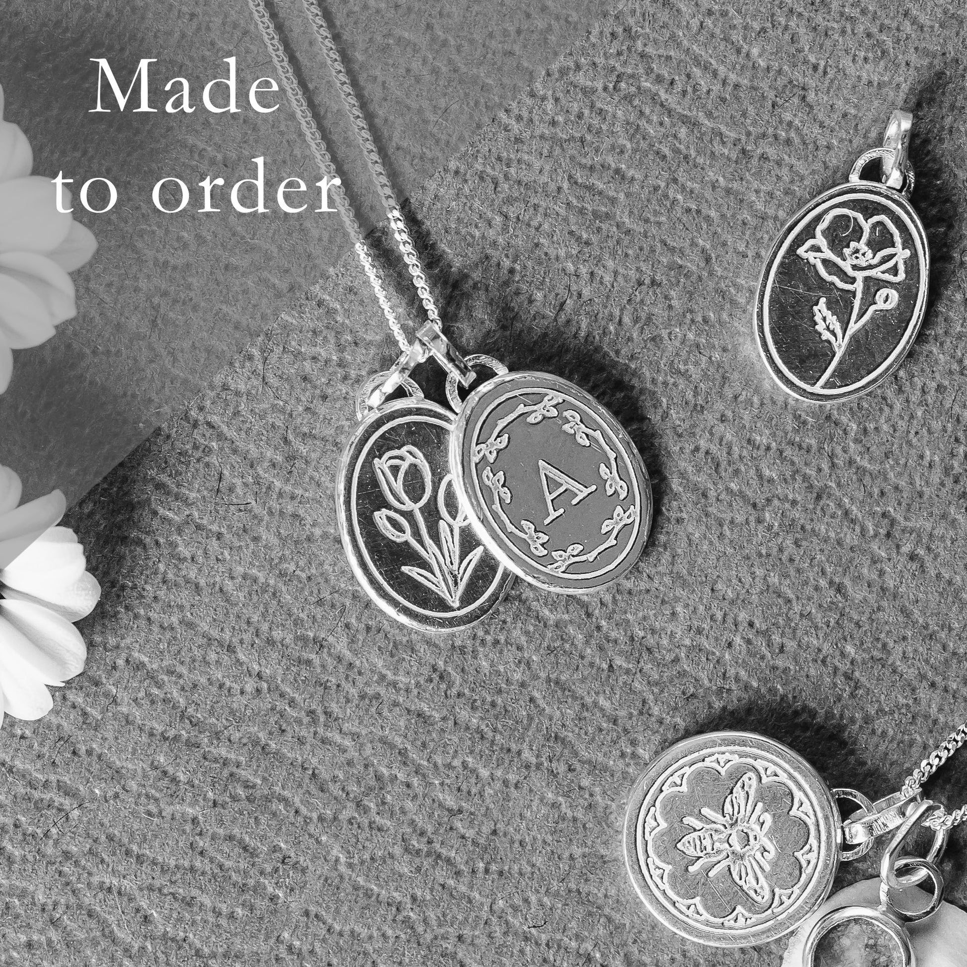 Gold initial necklace made to order pictured with some other engraved necklaces