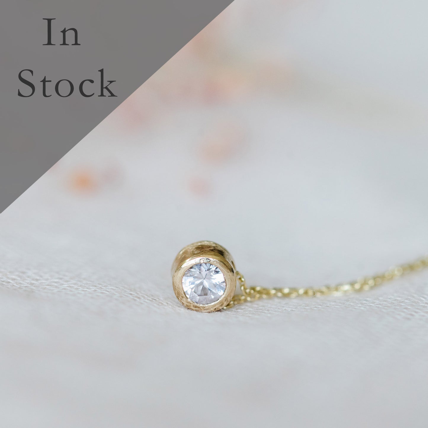 White sapphire solitaire necklace in 9ct yellow gold