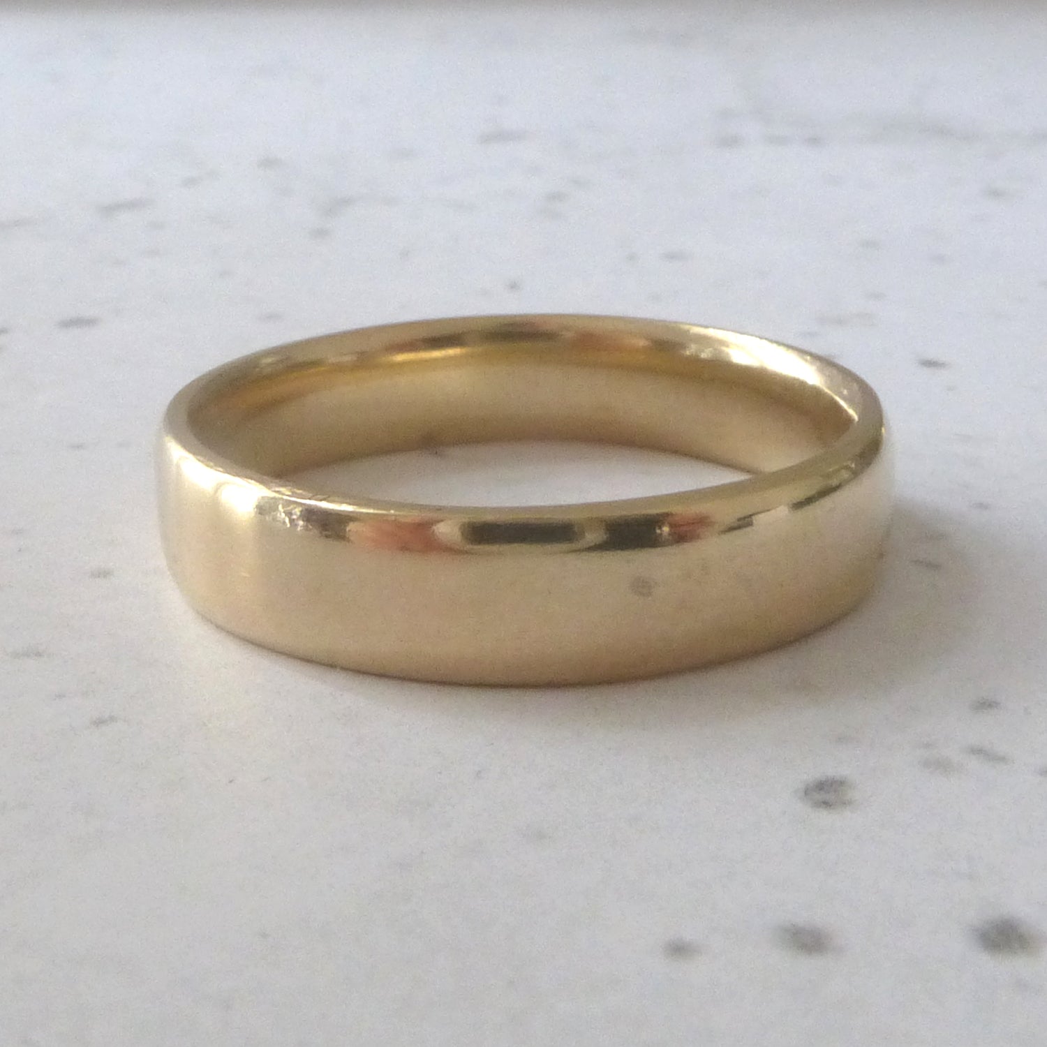 Hand made wedding ring in recycled 9ct yellow gold, soft court profile, smooth finish