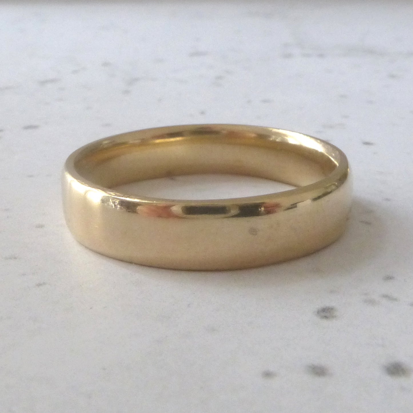 Smooth handmade wedding band in recycled 9ct yelllow gold, soft court profile