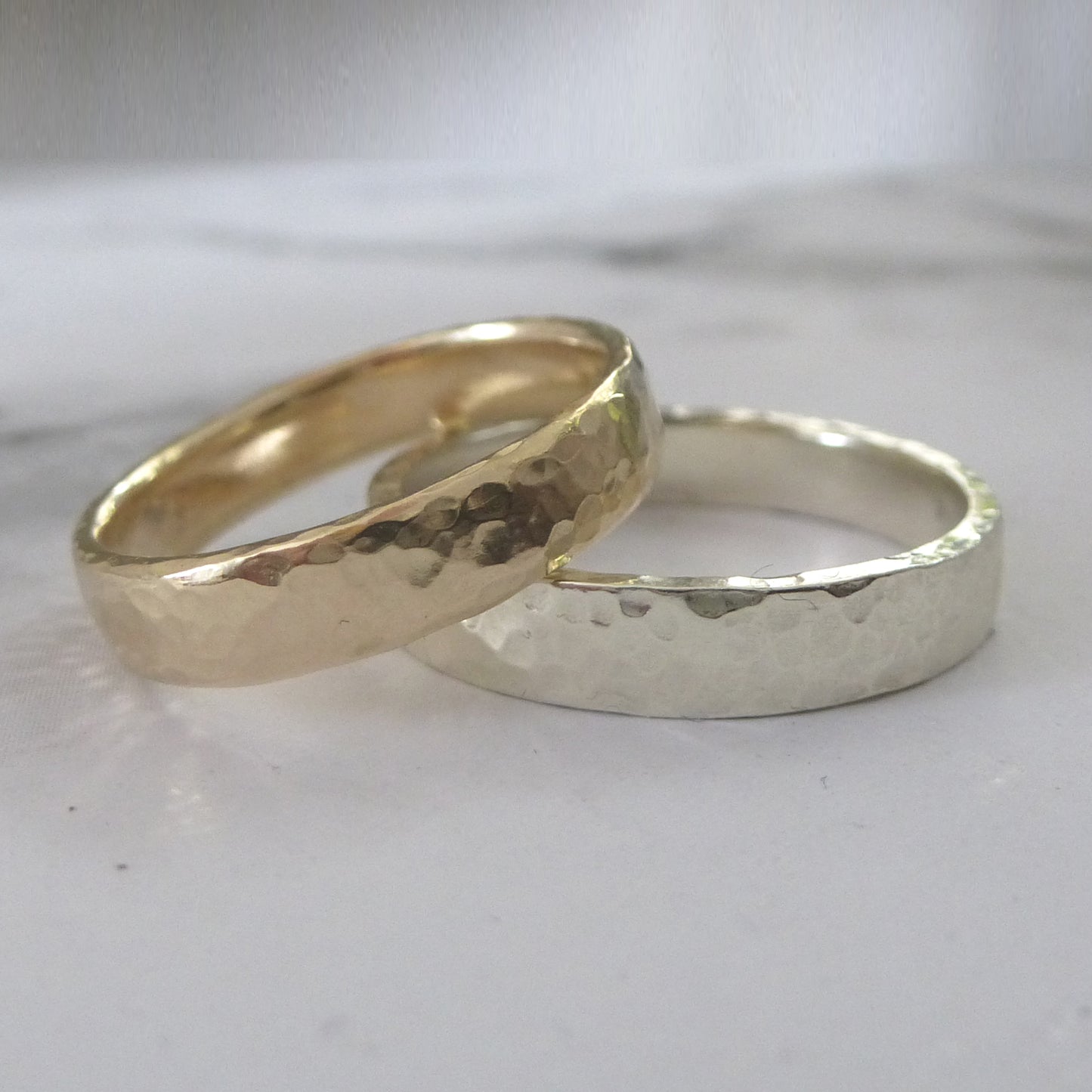 A pair of handmade wedding bands, 9ct recycled gold, upper band 9ct yellow, lower band 9ct white