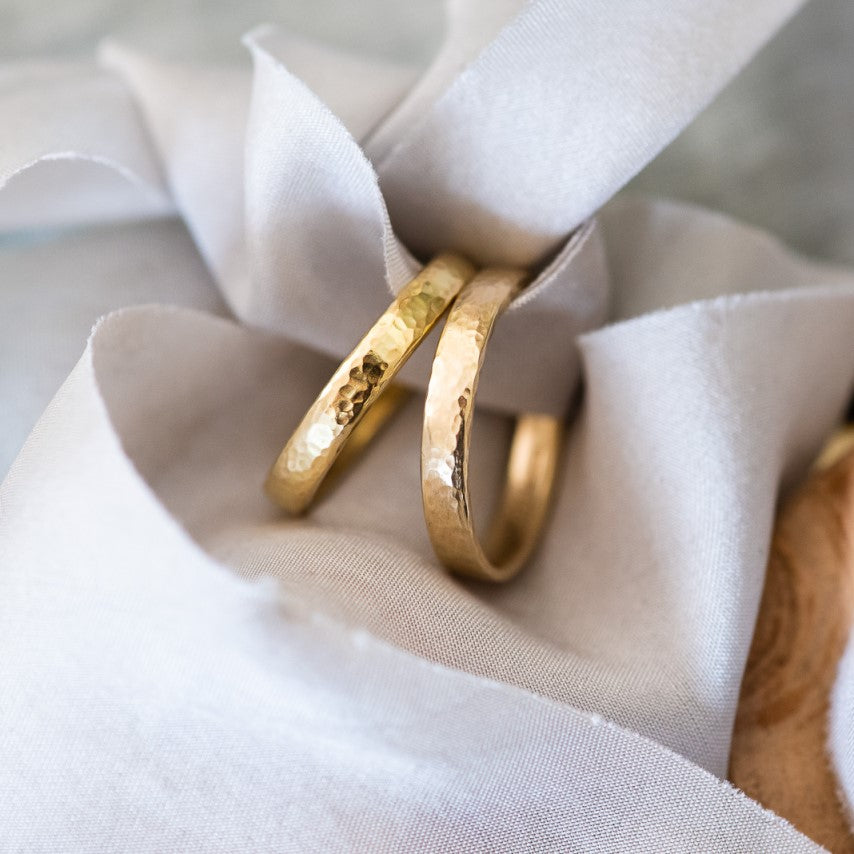 A pair of gold wedding rings, one in 18ct and one 9ct yellow gold.