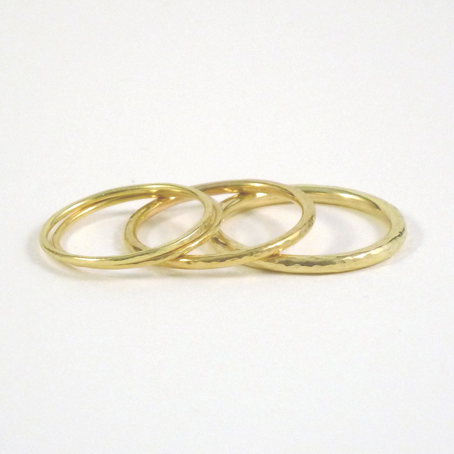 3 stacked bands, from the left 1mm, 1.5mm and 2mm, 18ct yellow gold, hammered finish
