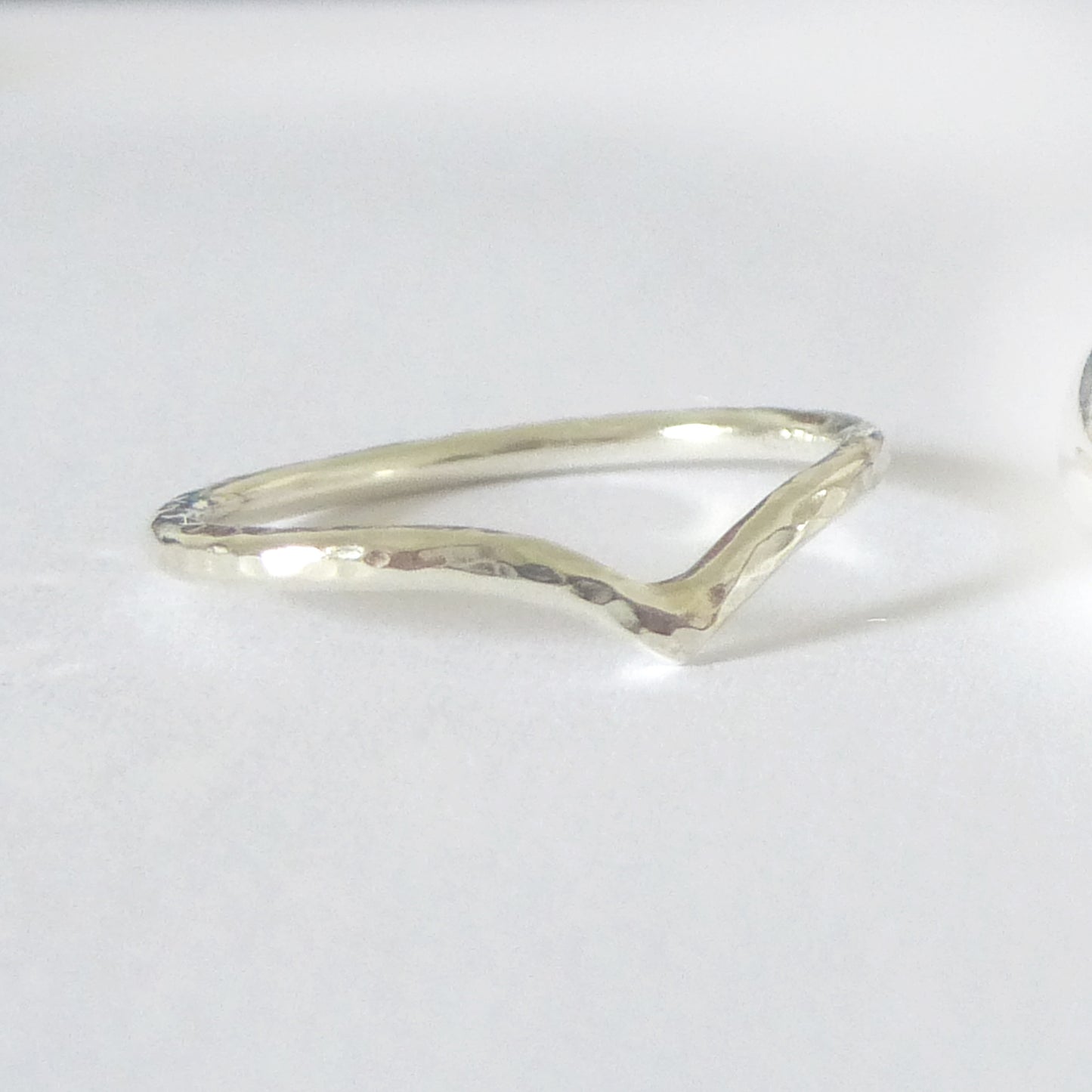9ct white gold wishbone ring with hammered finish on white background