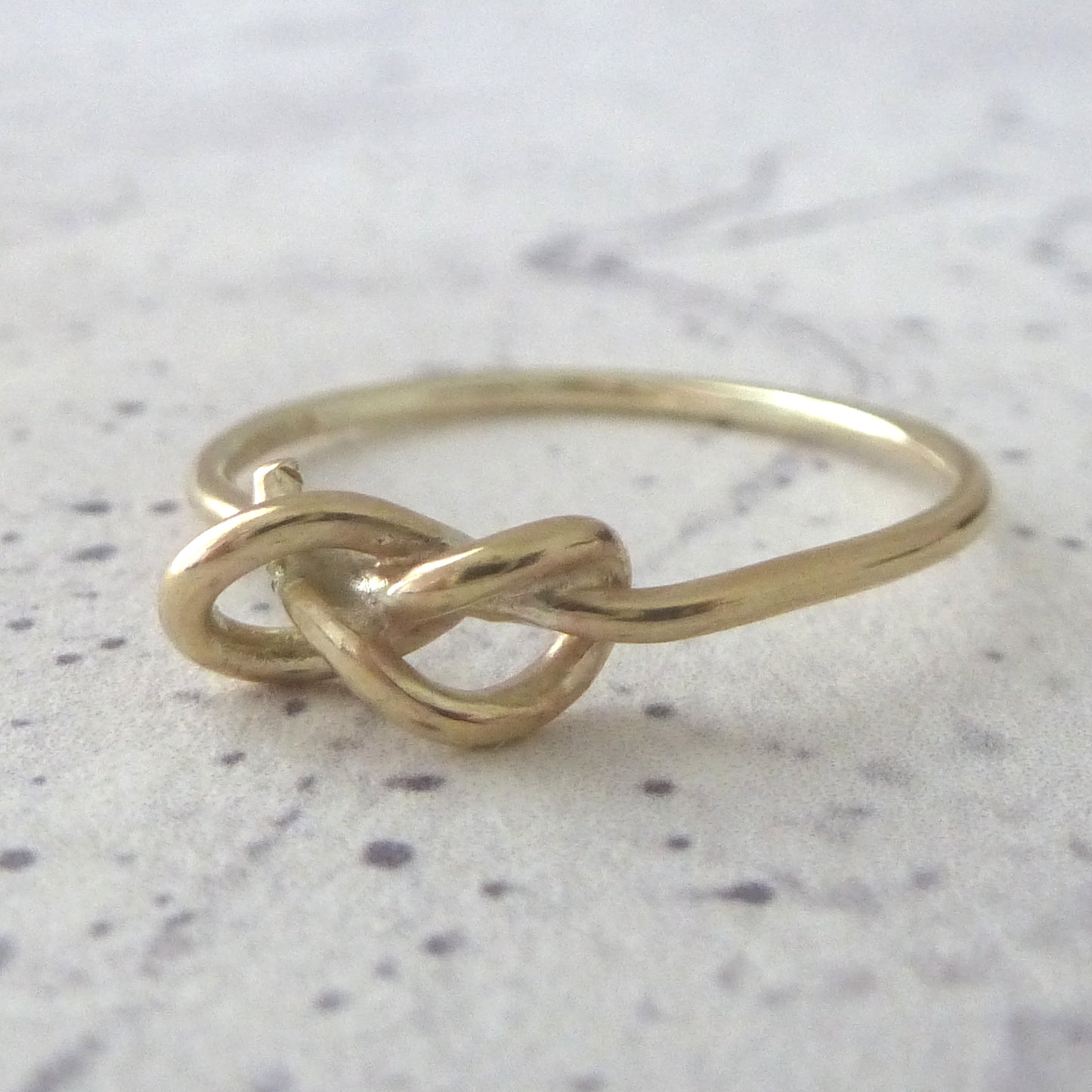 Slim 9ct yellow gold knot ring, close up