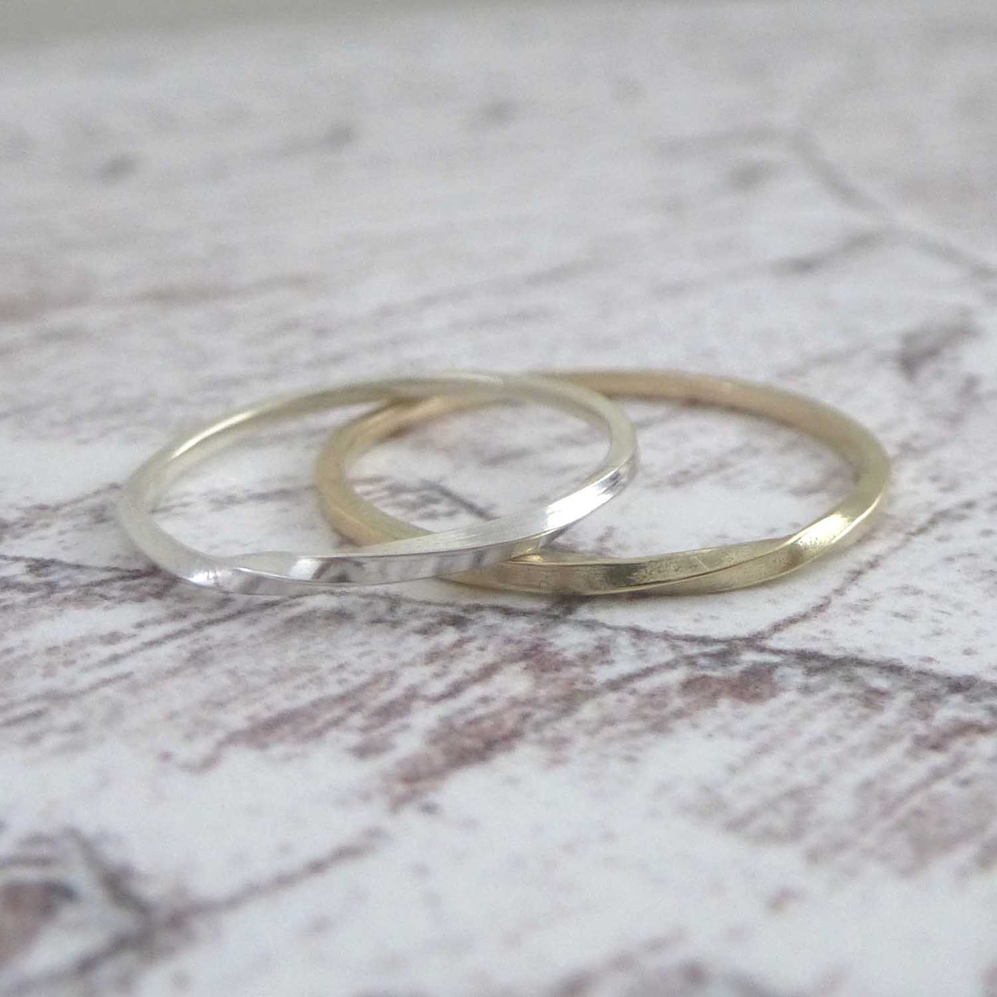 A pair of twist rings one silver and one 9ct gold