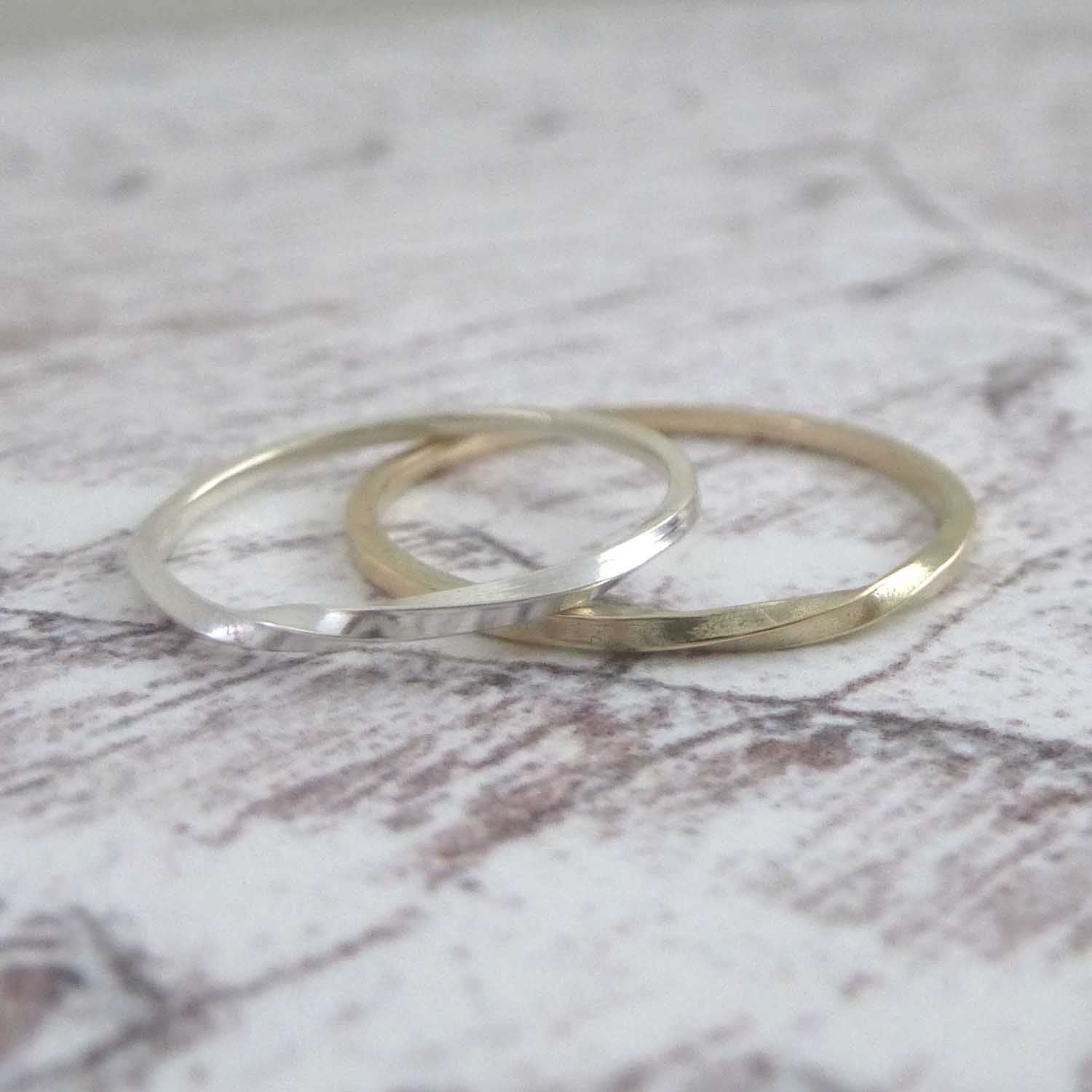 A pair of twist rings one silver and one 9ct gold