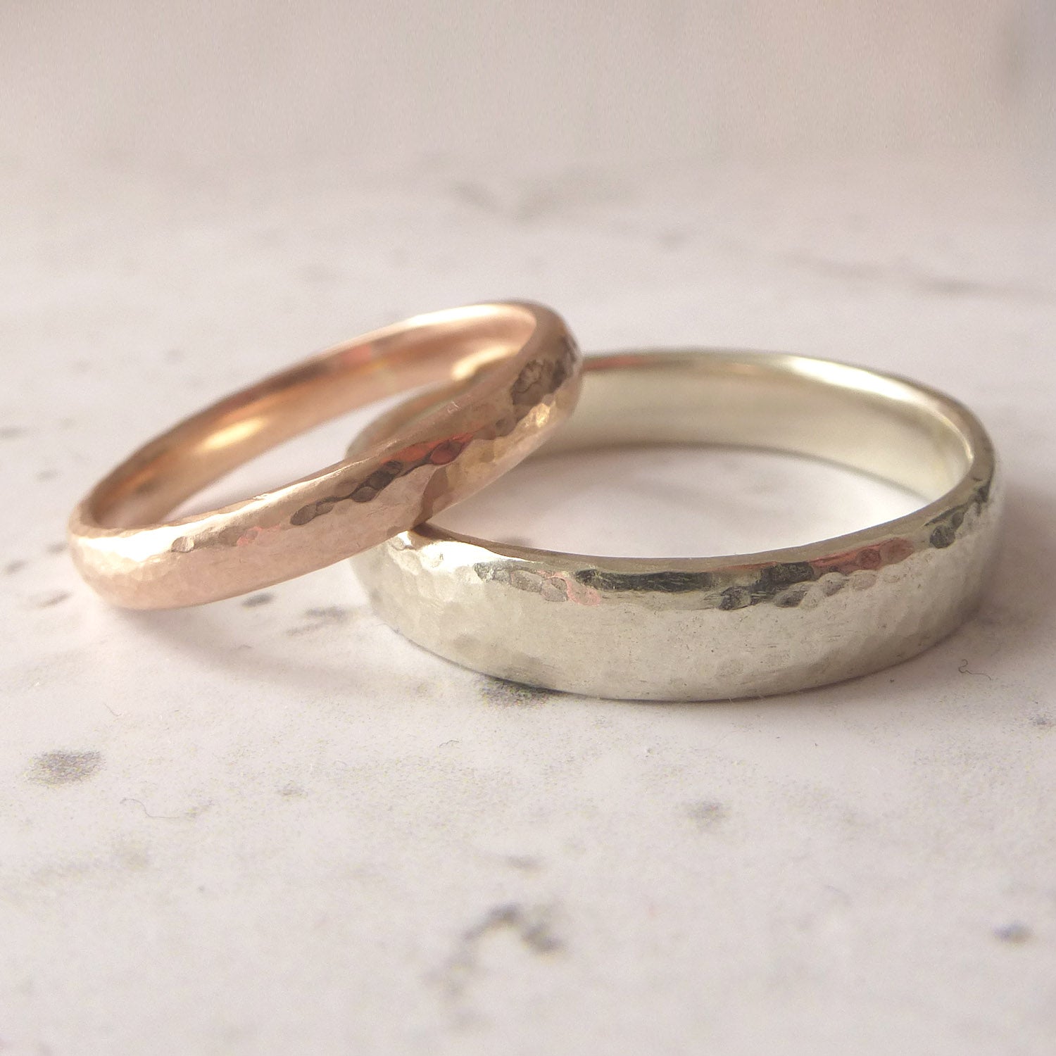 A pair of handmade wedding rings, 3mm in 9ct rose gold, 4mm in 9ct white gold
