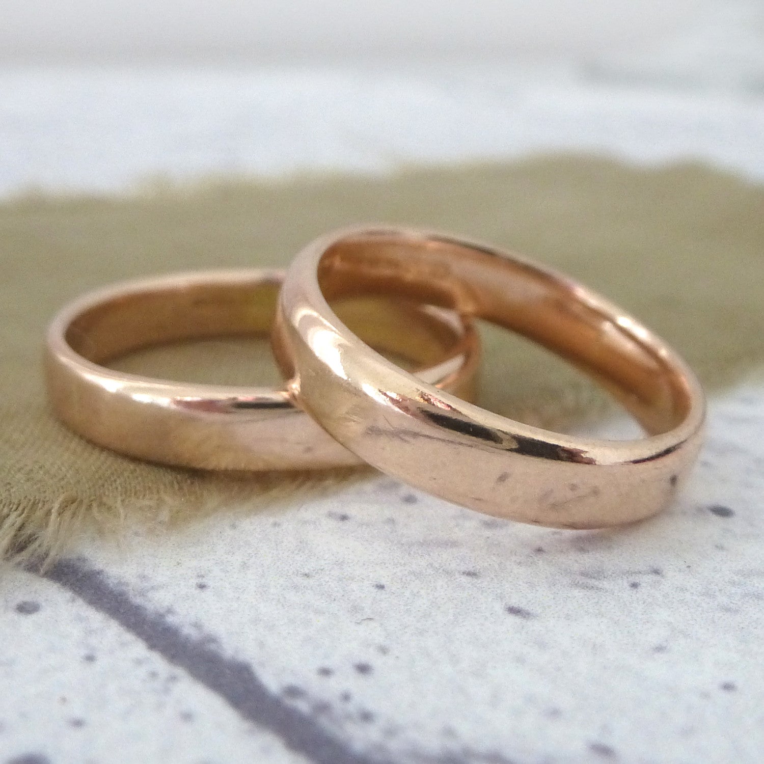 A pair of smooth finish 9ct rose gold wedding bands, 4mm